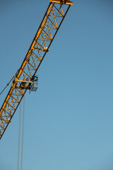  Construction Yellow crane against blue sky
