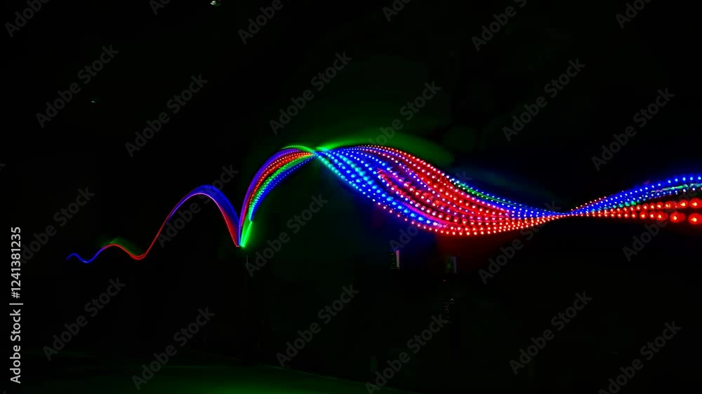 Poster dynamic display of multicolored led light waves forming vibrant patterns on a dark background, showc