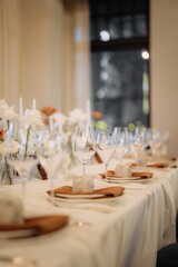 stylish details of a decorated festive table in a restaurant with a blurred background
