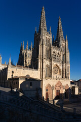 Fototapeta premium Gothic cathedral facade of the city of Burgos at sunset in a suuny day. Castilla y Leon, Spain.
