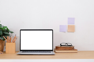 Work desk in a white room And there is a note-taking device on the table. front view