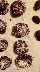 Sweet chocolate candies dusted with coconut, resting on romantic valentines surface in prague