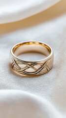 Showcasing an elegant wedding ring soft fabric background jewelry photography intimate setting close-up view intricate celtic knot design for eternal love