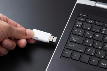 パソコンにUSBメモリを差し込む手元