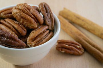 Pecan nuts and cinnamon sticks close up