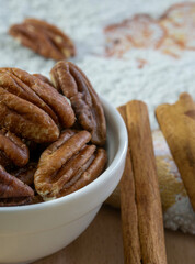 Pecan nuts and cinnamon sticks close up