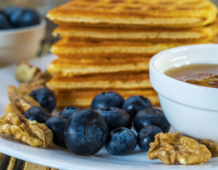sweet waffles with blueberries and honey close-up