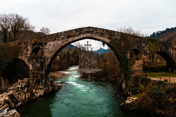 Ancient Stone Bridge over River. Roman Bridge Cangas de Onis
