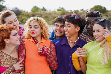 Group of young multiracial people hugging each other while wearing trendy retro style clothes -...