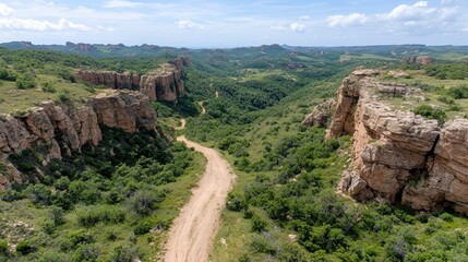 Aerial view of a dirt road winding through a canyon