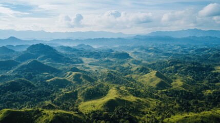 Naklejka premium Aerial view of lush green mountains, valley, and hazy horizon; nature background, travel brochure
