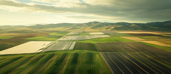 Aerial view Solar farm, agriculture, hilly landscape, sunset