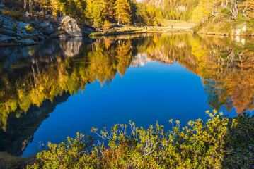 autumnal mountain landscape with a small lake inside the Alpe Devero, Val D'Ossola, Verbania, Italia	