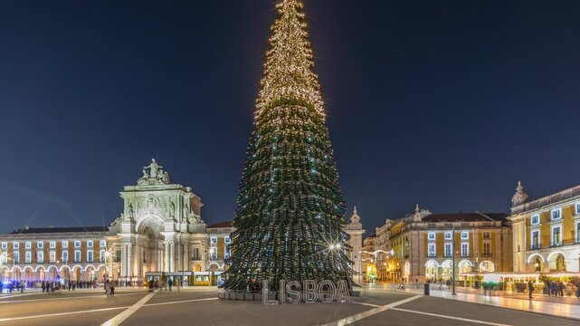 Commerce Square in Lisbon illuminated at Christmas day to night transition hyperlapse, with a towering tree and crowds celebrating. Timelapse of the festive atmosphere and historic architecture