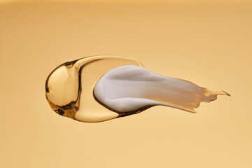 Textures of different cosmetic products on a gold background.