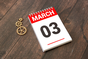 3 Marz on wooden grey cubes. Calendar cube date 03 March. Concept of date.