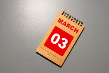 3 Marz on wooden grey cubes. Calendar cube date 03 March. Concept of date.