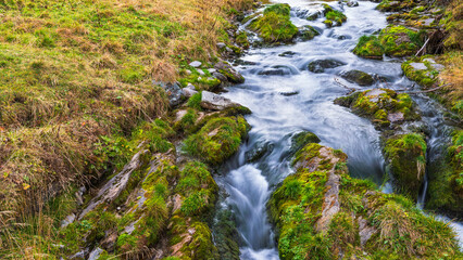 autumnal mountain landscape with a small stream  inside the Alpe Devero, Val D'Ossola, Verbania, Italia	
