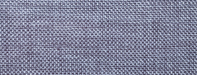 Texture gray background from woven textile material with wicker pattern, macro. Structure vintage silver fabric cloth