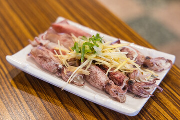 Delicious boiled squid served on table