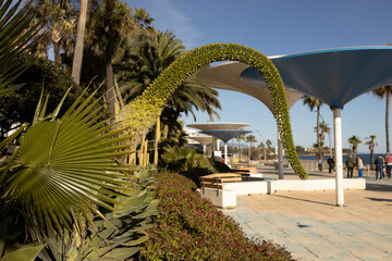 Plants and parasol shaped shade in Andalusian coastal town Estepona on the Costa del Sol. Spanish Sun Coast tourist destination © Maarten Zeehandelaar