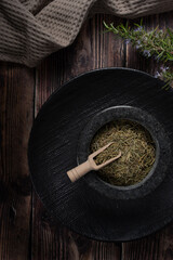 Rustic arrangement of dried herbs in stone bowl