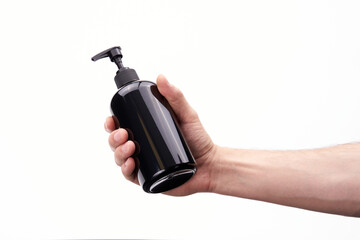 Naklejka premium Black plastic dispenser in hand on a white background
