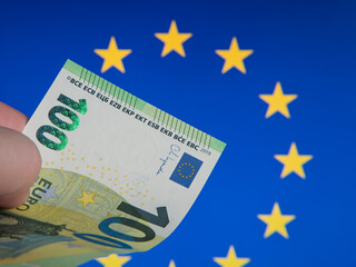 Euro Banknote Close-Up Against European Union Flag