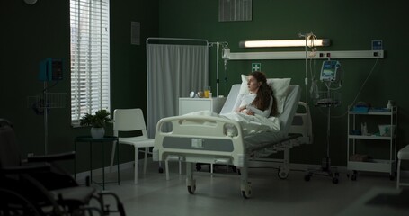 Young patient watches as the doctor approaches with important information on the tablet.