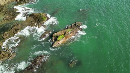 Sea beach with stones and azure clear water, houses on the shore. Drone video. Part 24