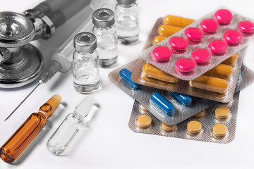medical tablets in a blister, medical ampoules with medicines and a medical syringe.