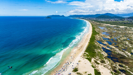 Preserved Brazilian beach with sandbanks and splendid nature on a sunny day with green sea
