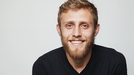 Obraz premium portrait of a young man with a beard smiling with a white background 