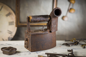 Rusty Vintage Iron with Wooden Handle Sitting on a Table