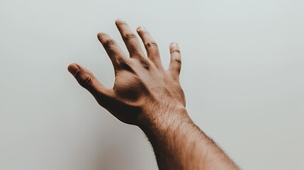 a man holding his hand up to the sky 