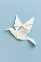 Fototapeta premium White dove bird made of white folded paper, symbolizing peace, origami bird, isolated on white background