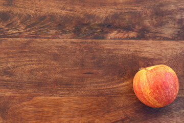 One apple on rustic wooden background with copy space