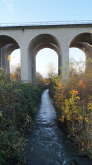 Railway bridge in the middle of the park in the city in autumn