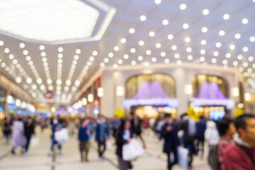 Blurred scene unidentified tourists shopping in department store with beautiful light