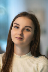 Portrait of a young beautiful dark-haired girl in a cafe.