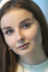 Portrait of a young beautiful dark-haired girl in a cafe.