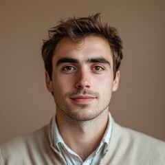 Obraz premium Young man with light brown hair wearing a sweater poses confidently against a neutral background in a studio setting. Generative AI