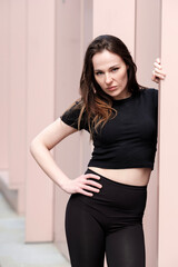 Confident dancer posing in urban setting, showing strength and grace
