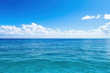 Fototapeta premium Relaxing scene of a serene ocean under a clear blue sky, inviting tranquility and peace on a beautiful day