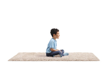 Excited kid sitting on a carpet