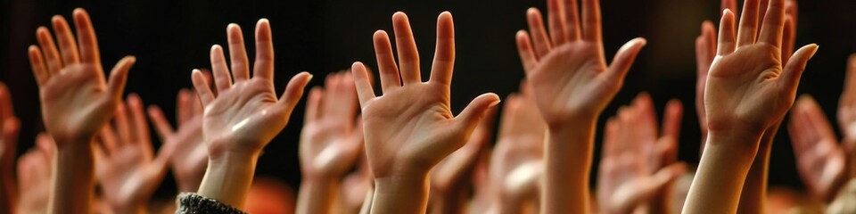 A group of people with their arms up in joy and excitement