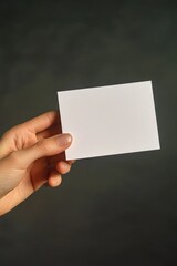 Obraz premium A person holding a document or note with important information