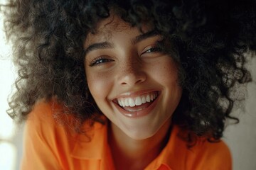 A smiling woman with a big afro hairstyle poses for the camera