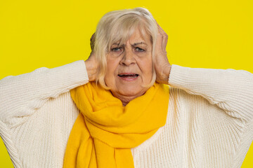Don't want to hear and listen. Frustrated annoyed irritated senior old woman covering ears...