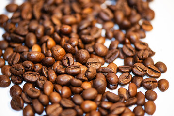 Close-up of rich brown coffee beans, showcasing their glossy sheen and unique textures. Perfect for coffee lovers and connoisseurs.